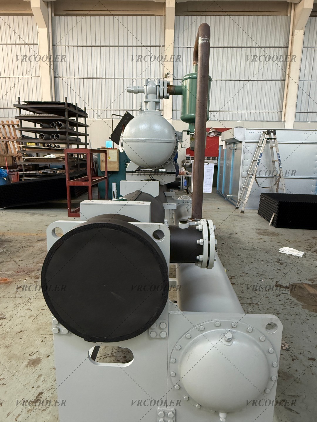 Why is a shell-and-tube heat exchanger used in water-source heat pumps?