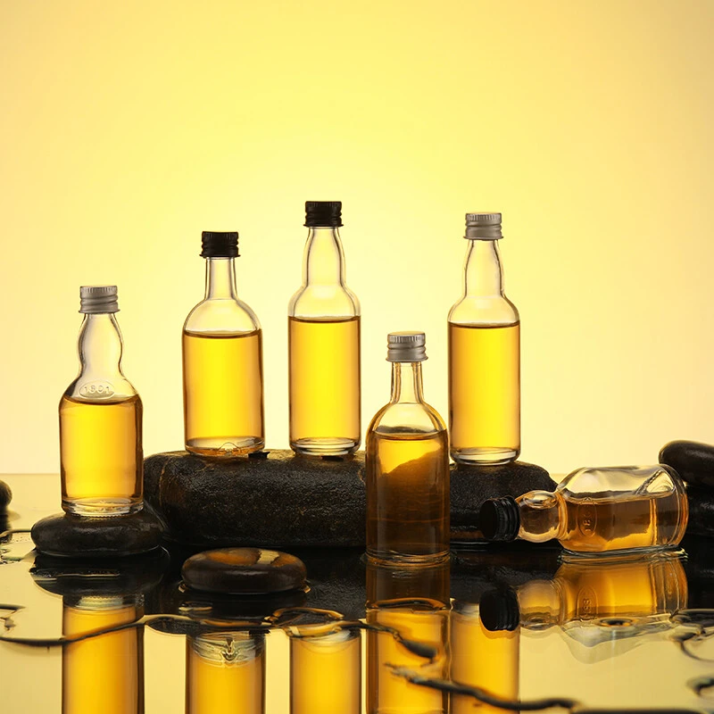 Mini botella de licor vacía de vino de vidrio